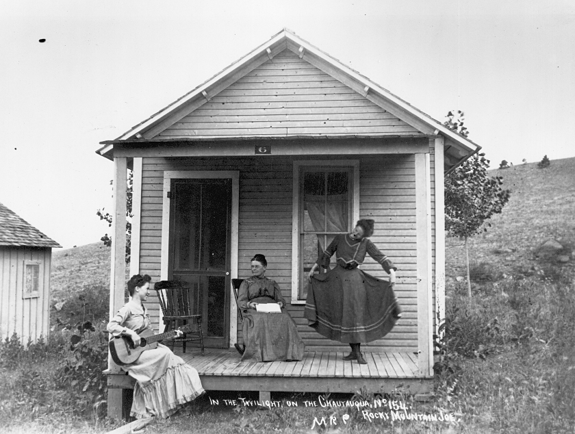 a group of women sitting on a porch of a house