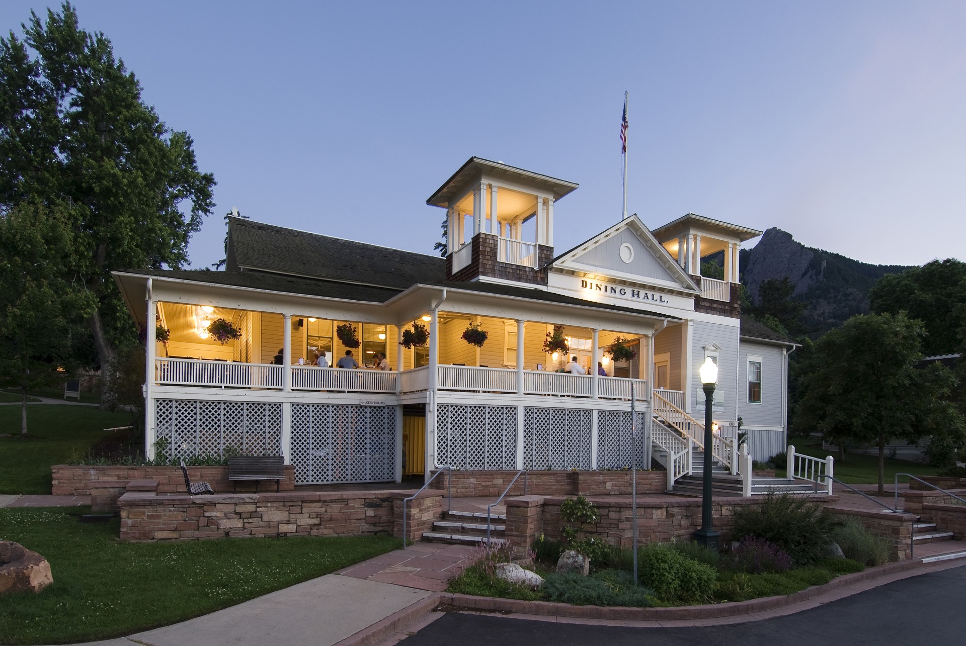 a building with a porch and a flag on the front