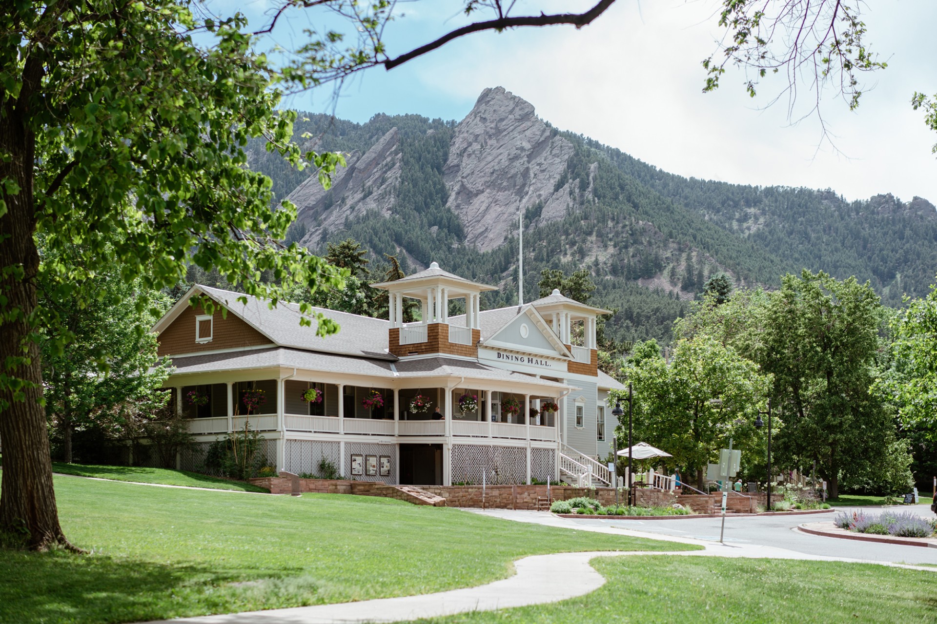 a building with a lawn and trees in front of it