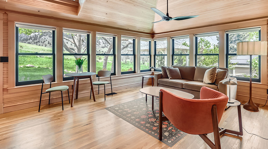 a room with a couch and chairs and a table and chairs