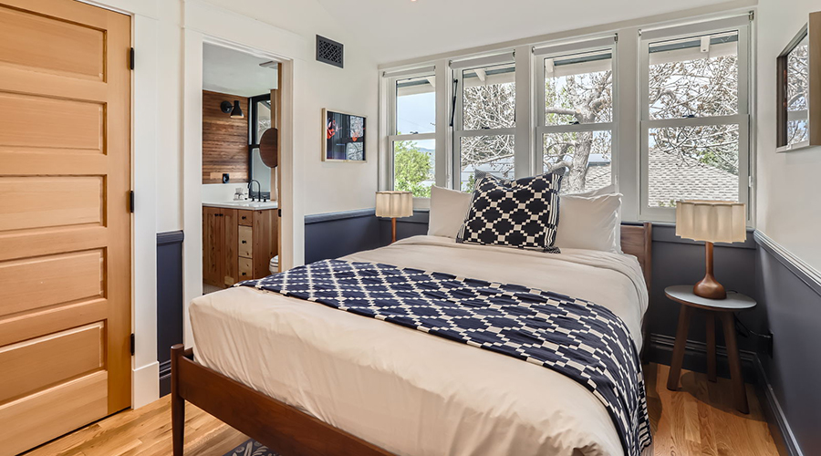 a bed with a white bedding and blue and white pillows
