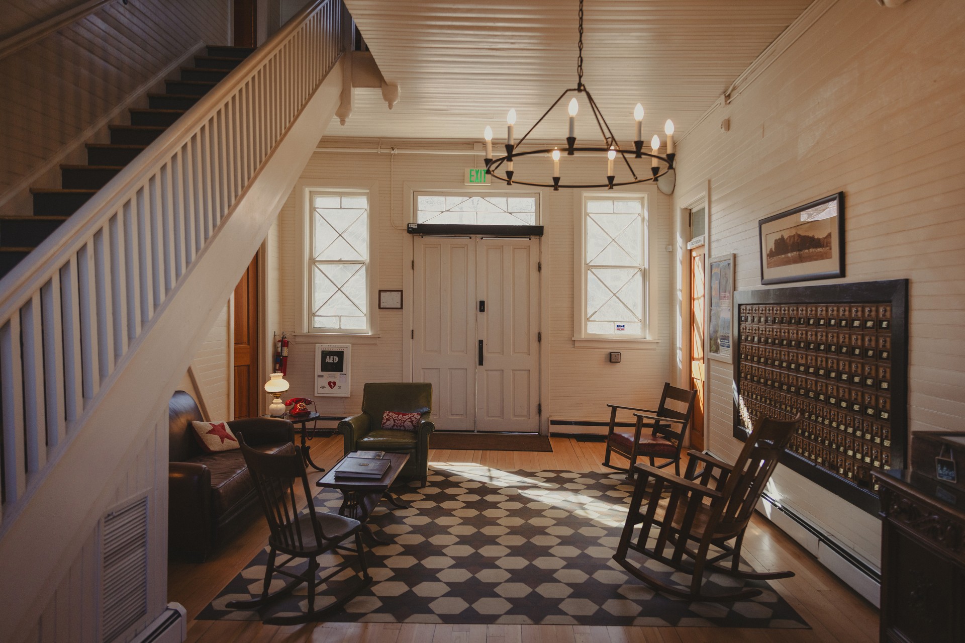 a room with a staircase and chairs