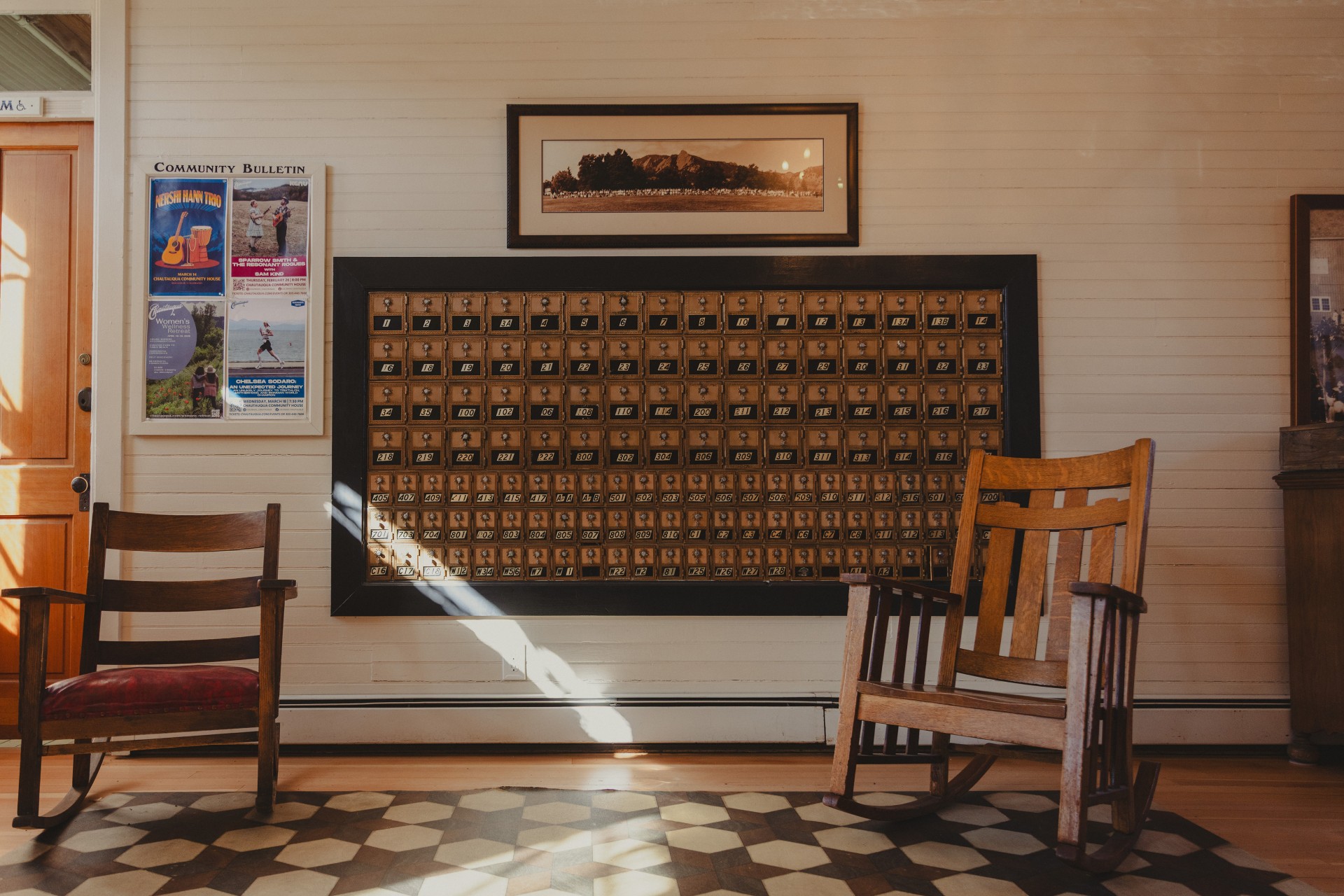 a room with rocking chairs and mailboxes