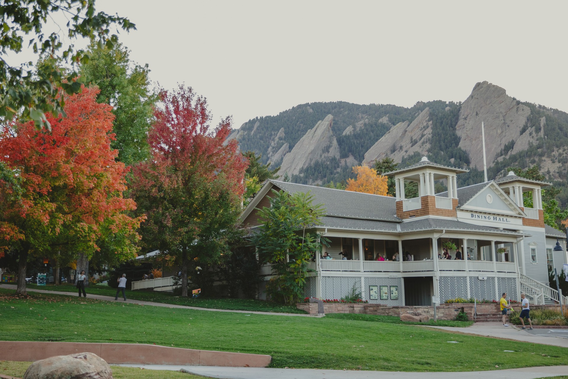 a house with trees and mountains in the background