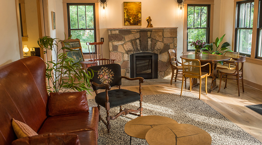 a living room with a fireplace and chairs