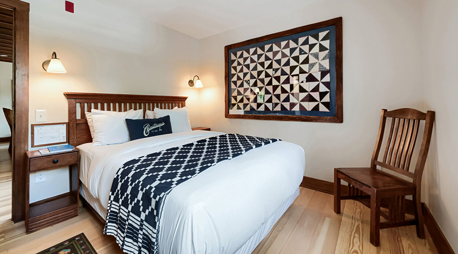 a bed with a blue and white blanket
