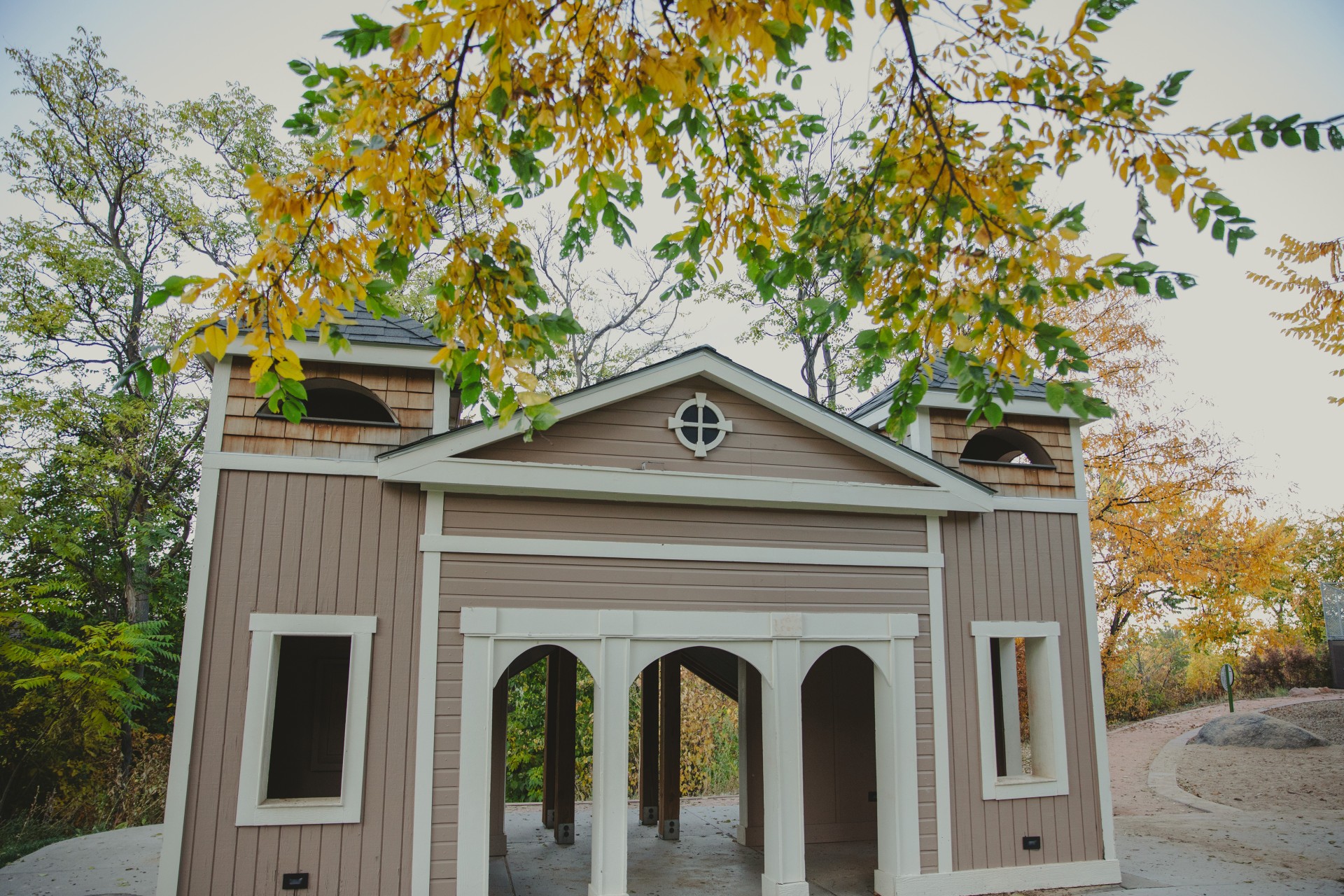 a building with a roof and a tree branch