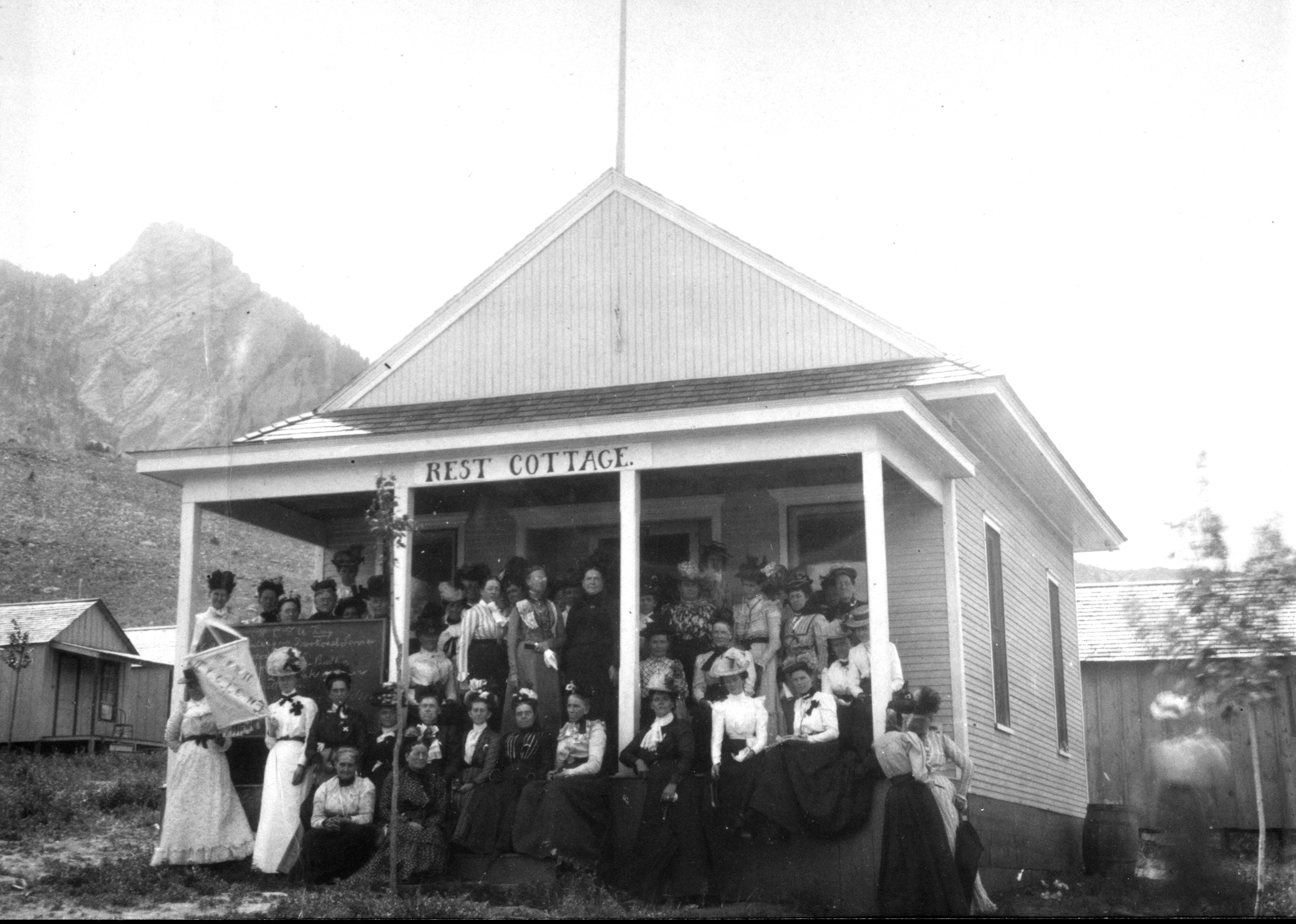 a group of people in front of a house