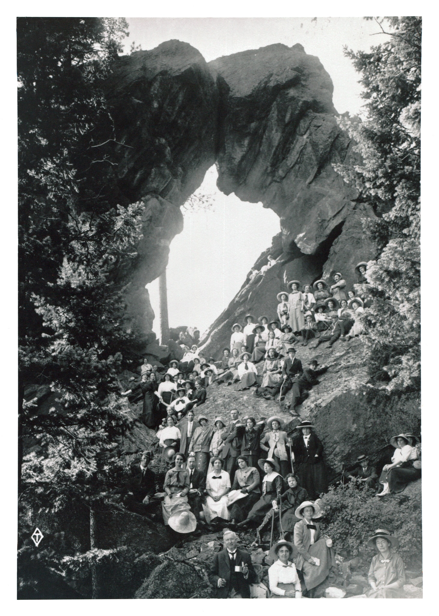 a group of people sitting on a rock