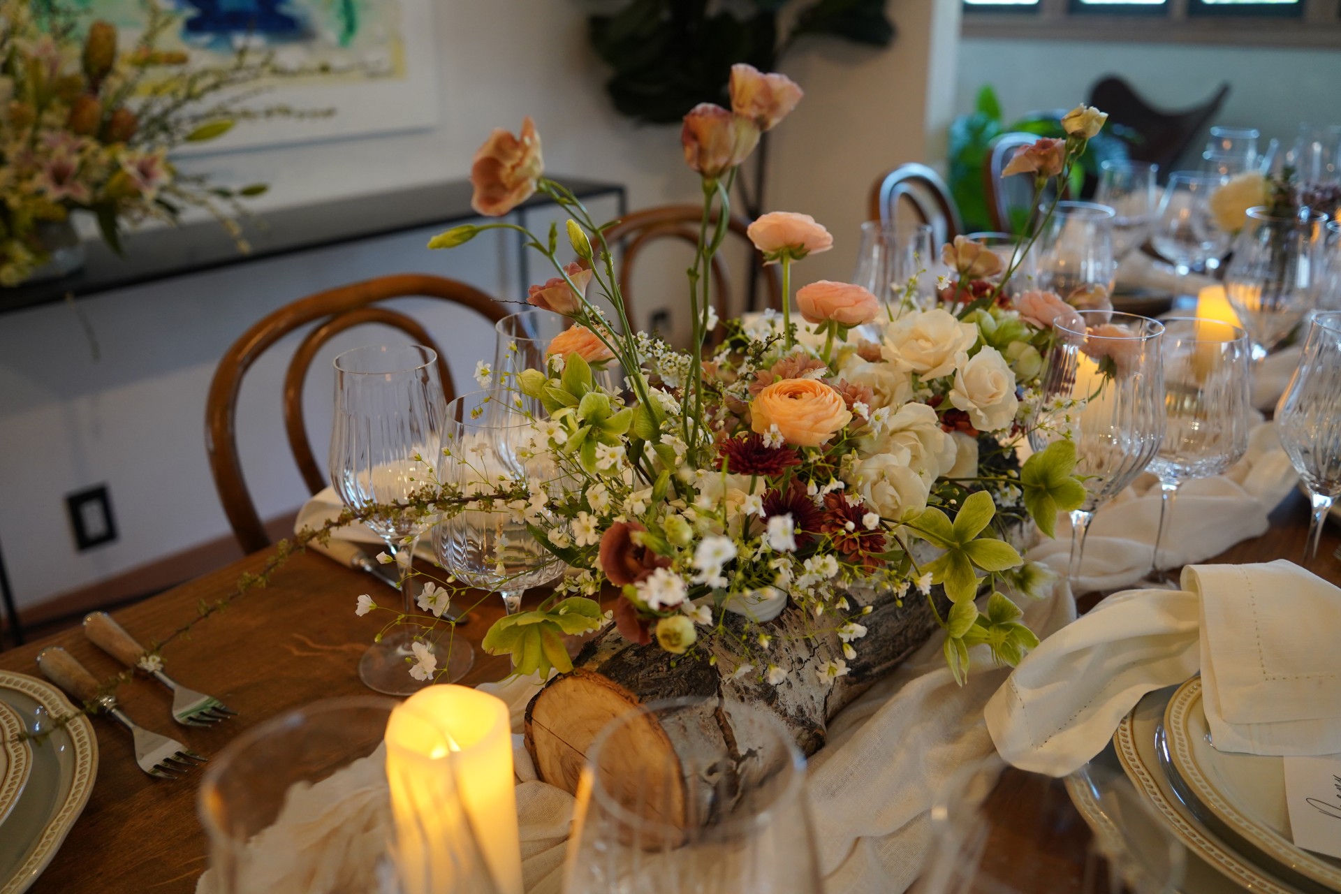 a table with flowers and wine glasses