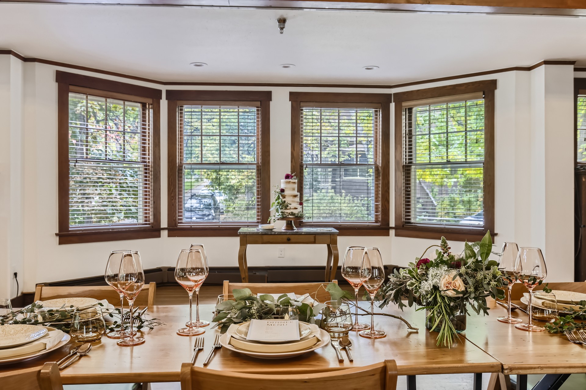 a table with flowers and glasses on it