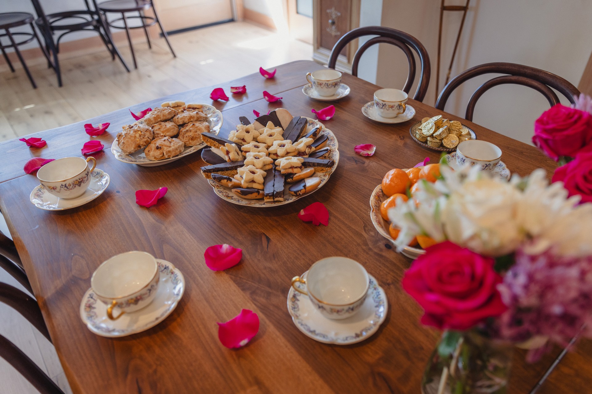 a table with plates of food and flowers