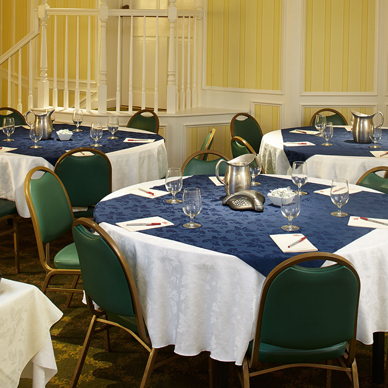 a group of tables with blue and white tablecloths