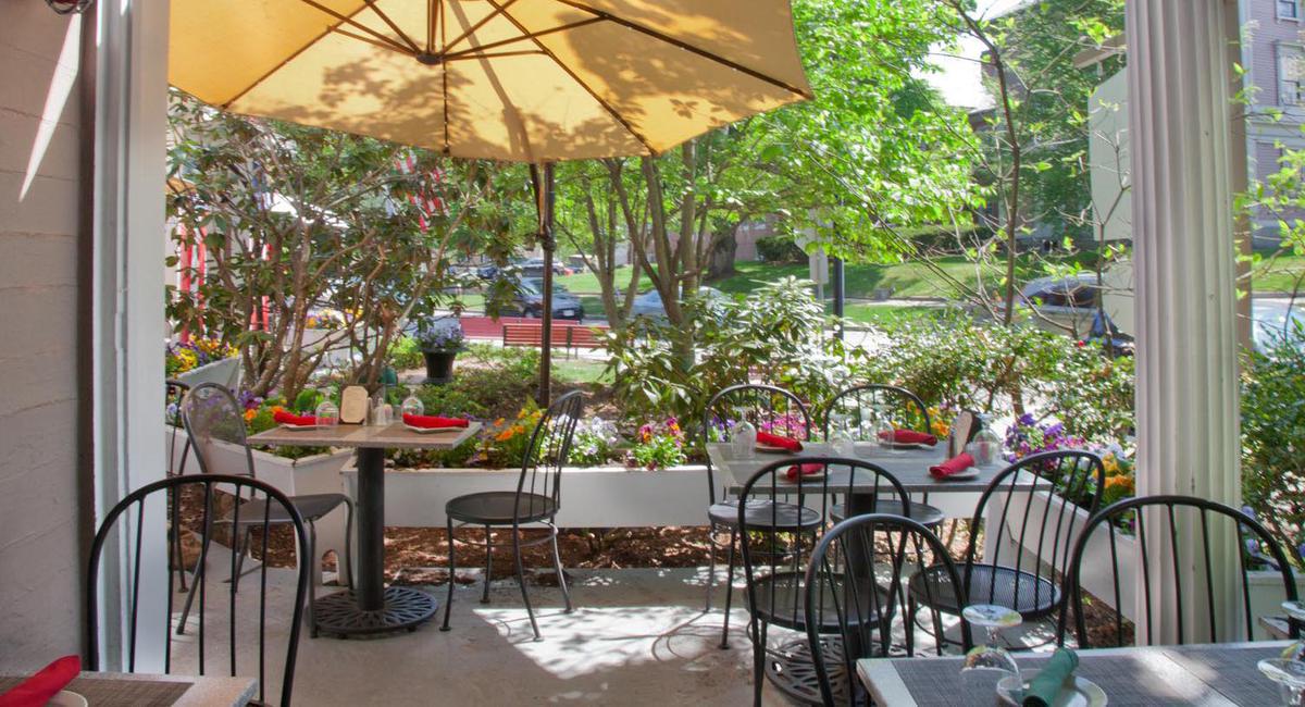 a table and chairs under an umbrella