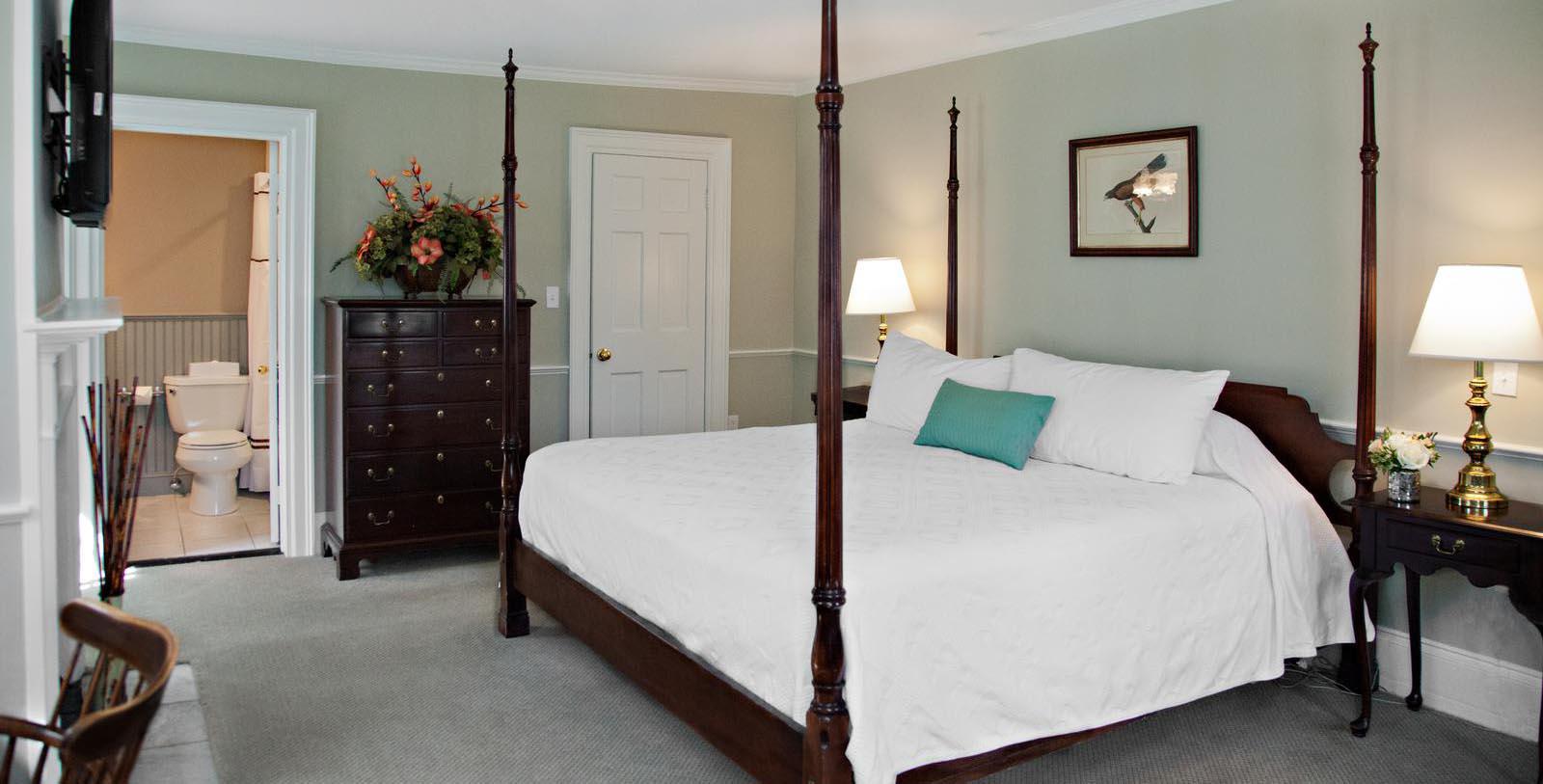a bedroom with a four poster bed