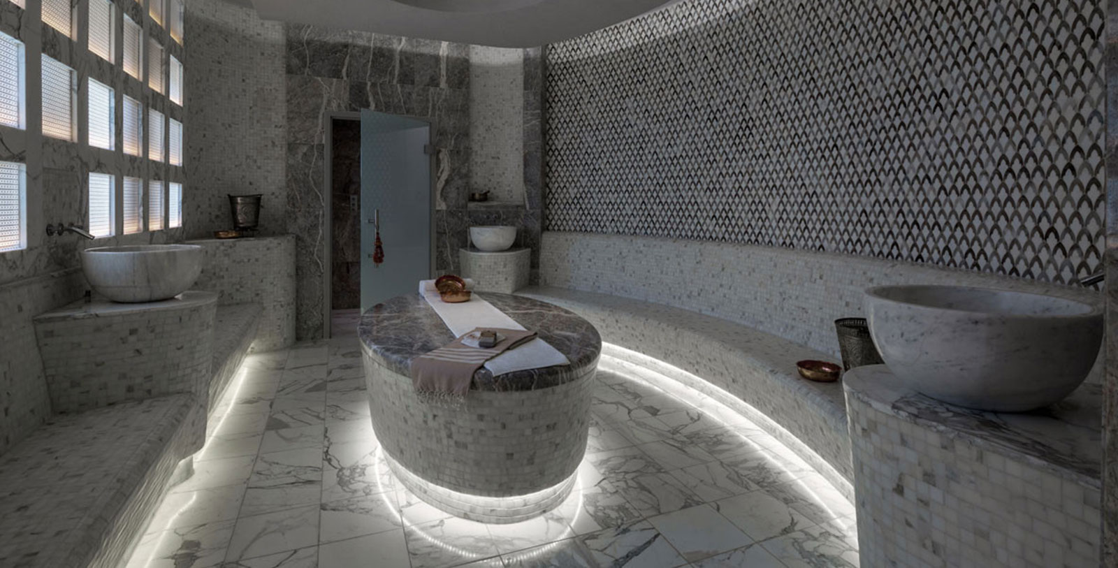 a room with a round table and a bench