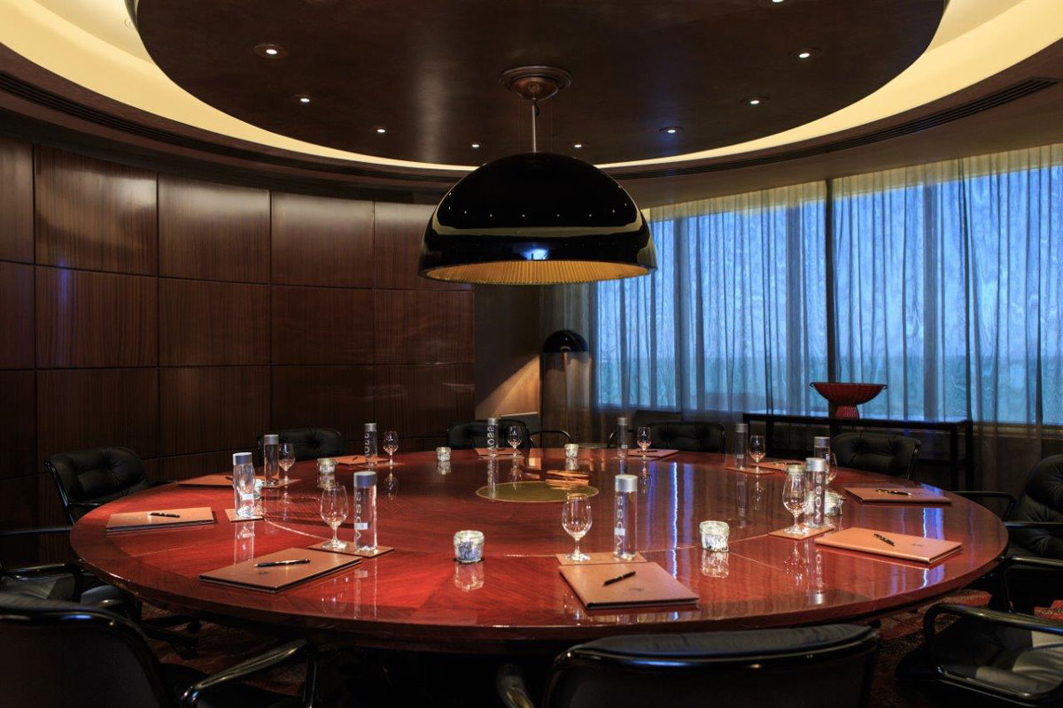 a round table with glasses and utensils in a room