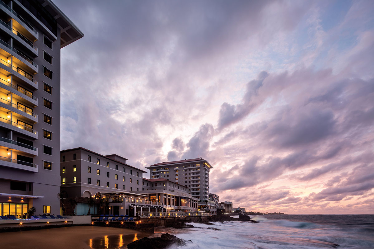 a building next to the ocean