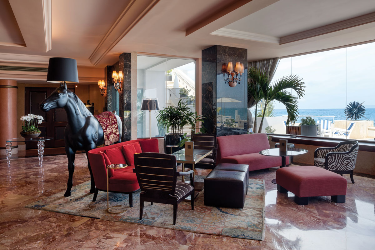 a room with a horse statue and a couch and a table