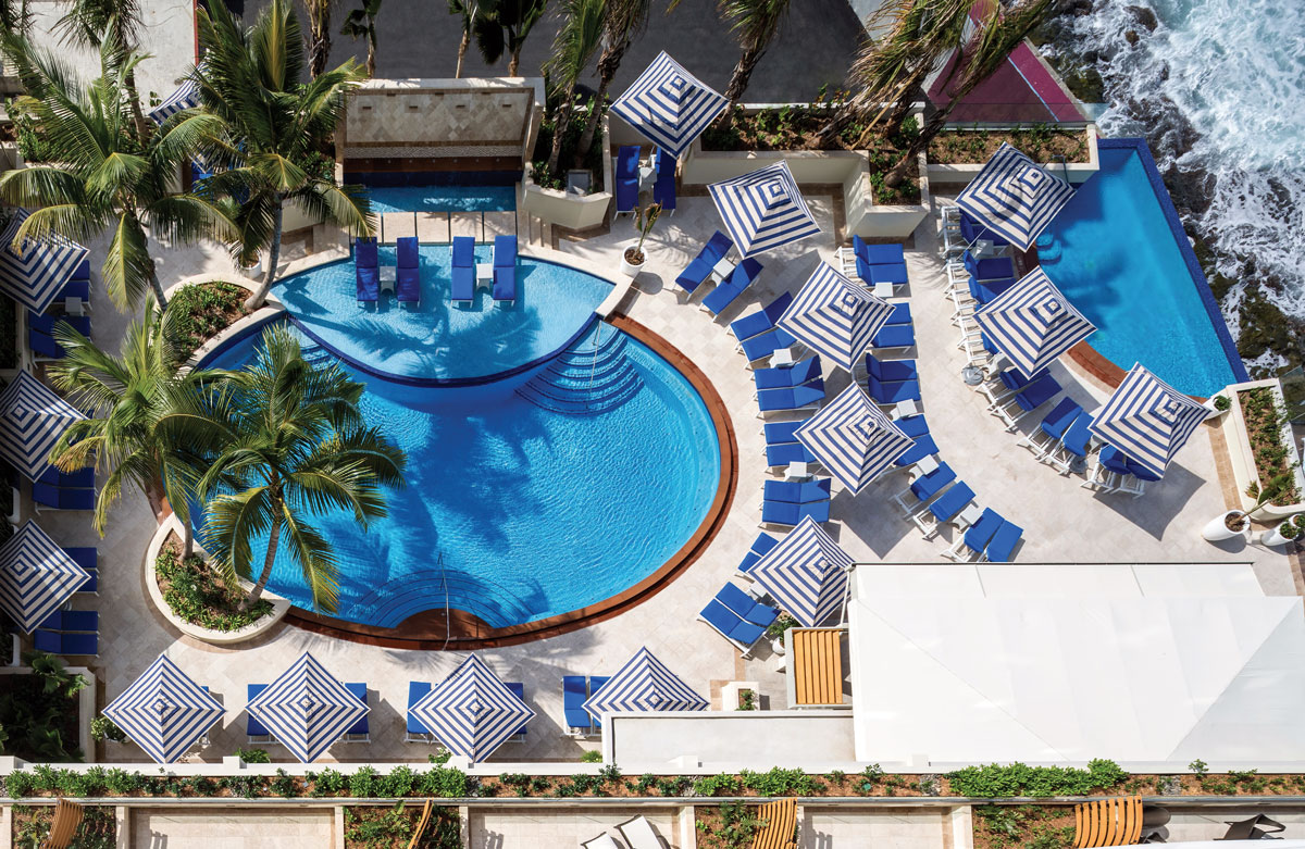 a pool with umbrellas and chairs