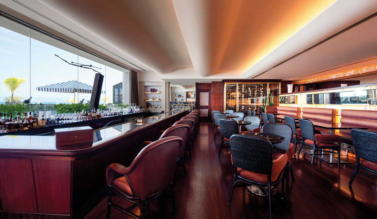 a room with a bar and chairs