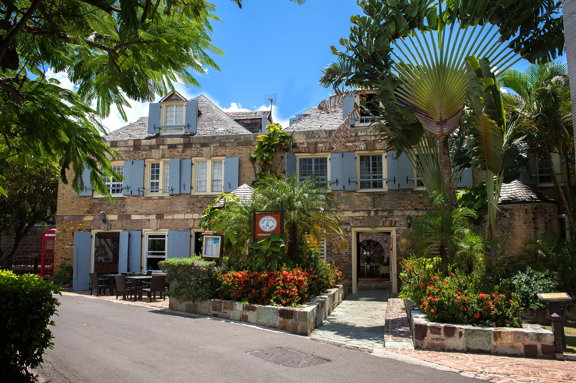 image of exterior entrance and road copper and lumber store historic inn english harbour antigua and barbuda_high