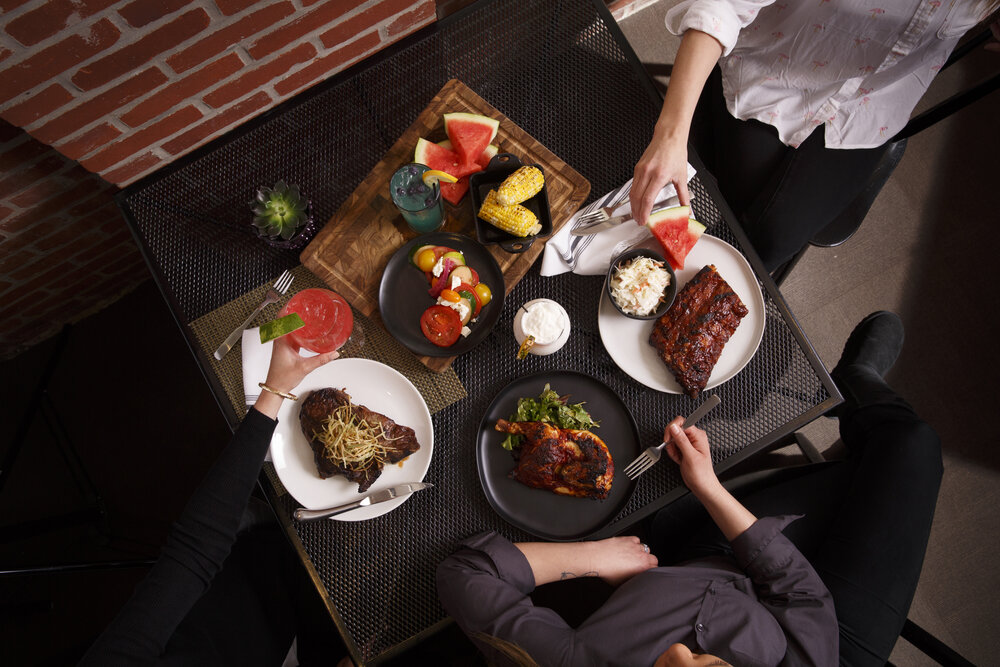 a group of people eating food at a table