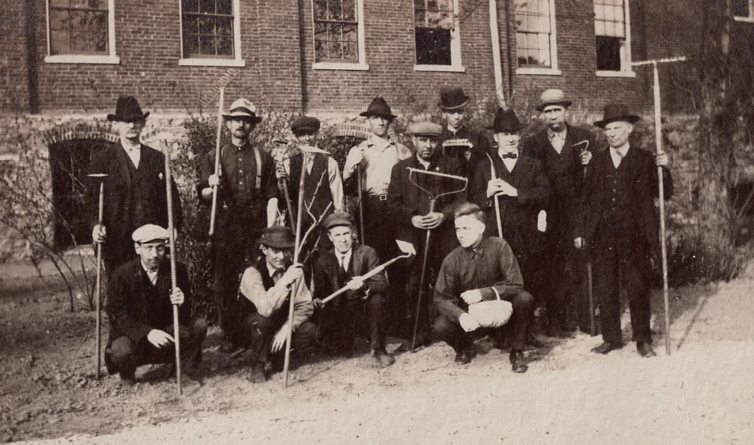 a group of men holding tools
