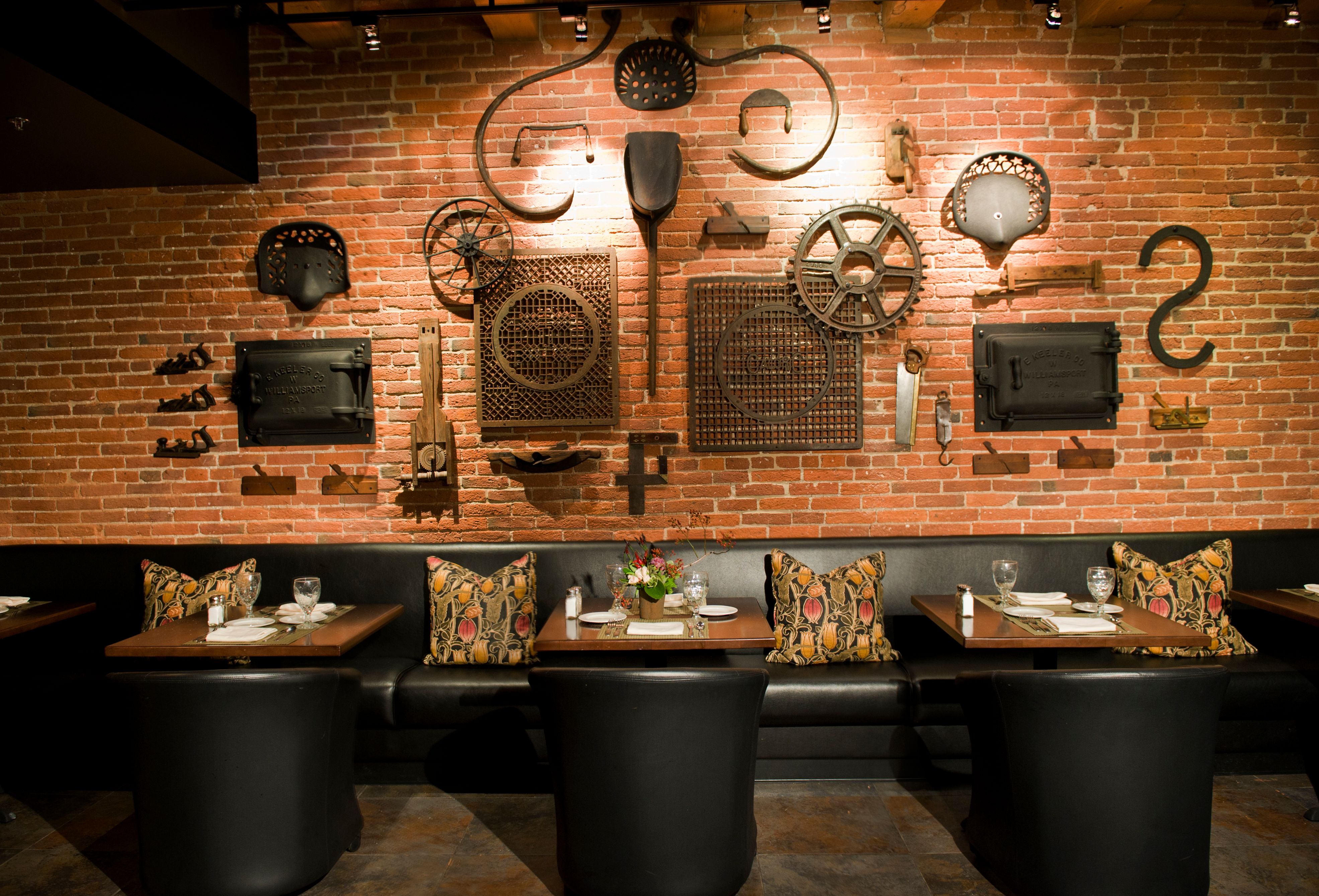 a restaurant with a brick wall and a brick wall with a table and chairs