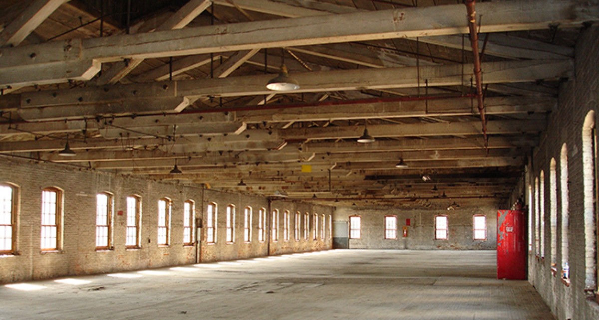 an empty warehouse with many windows