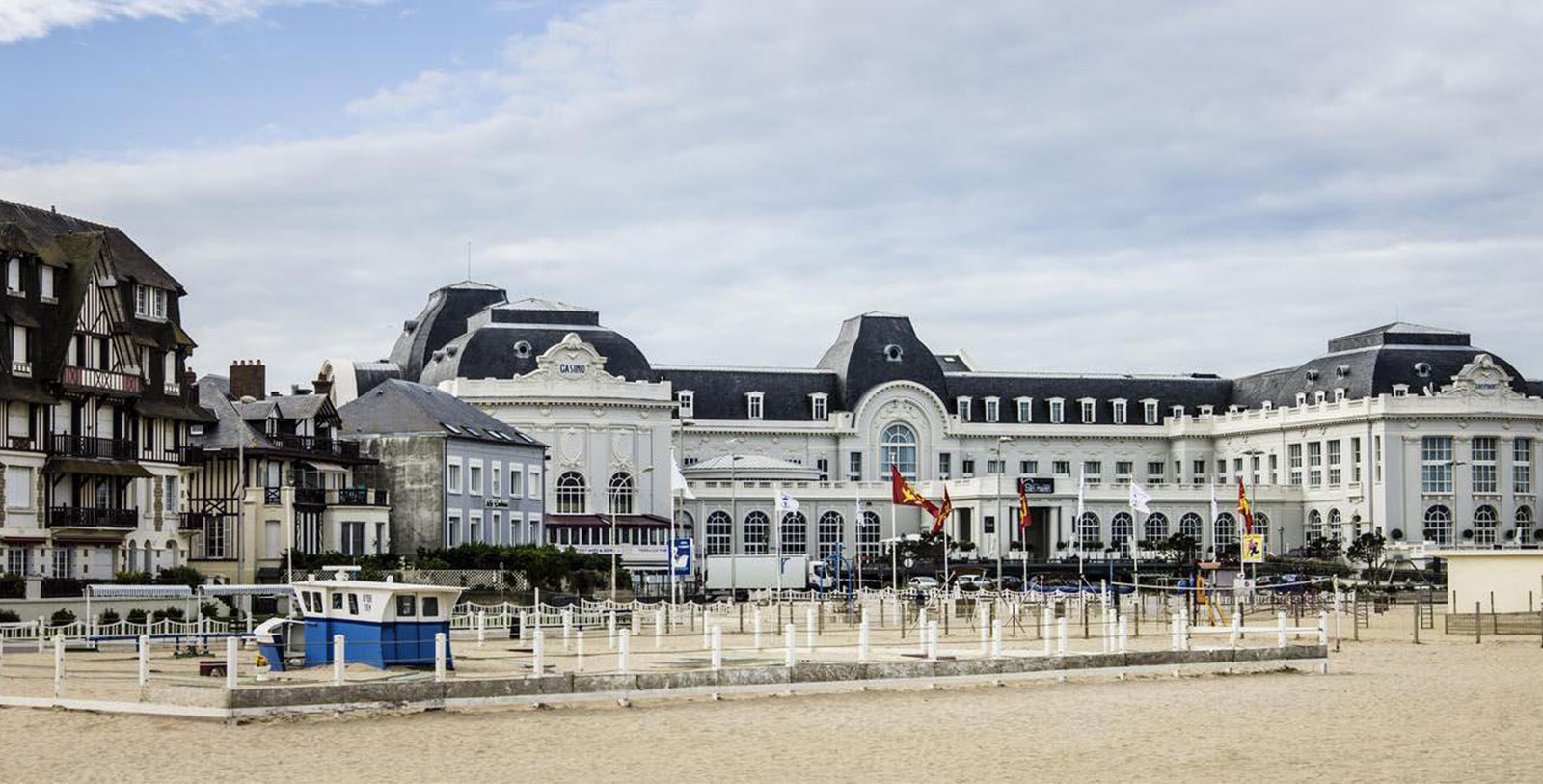 a large building with flags in front of it