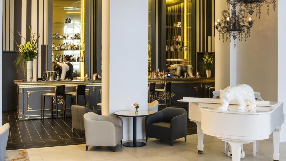 a white piano and chairs in a restaurant