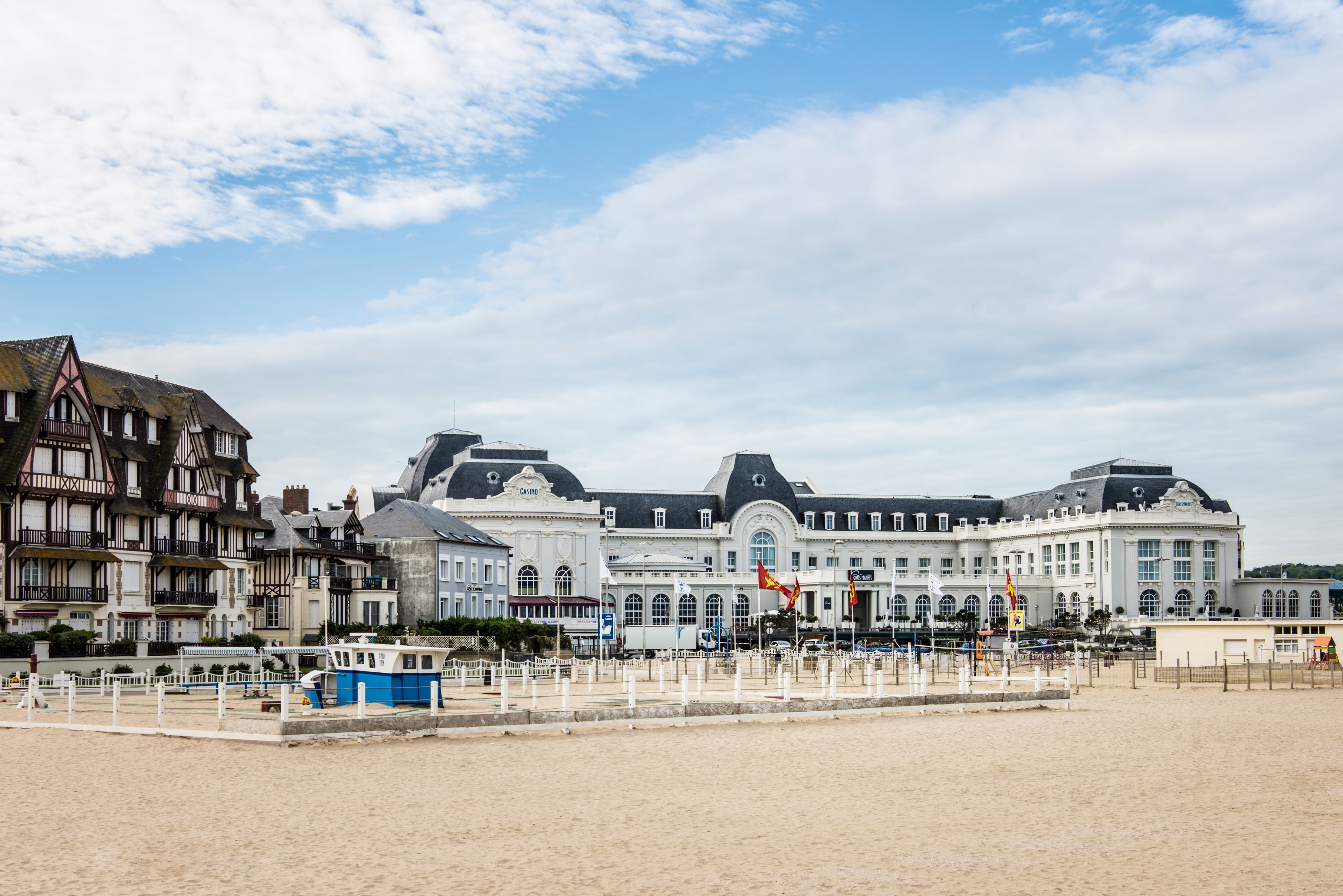 a large building with many windows and a sandy beach