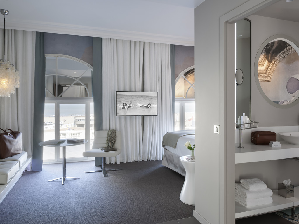 a room with a bed and a table and chairs