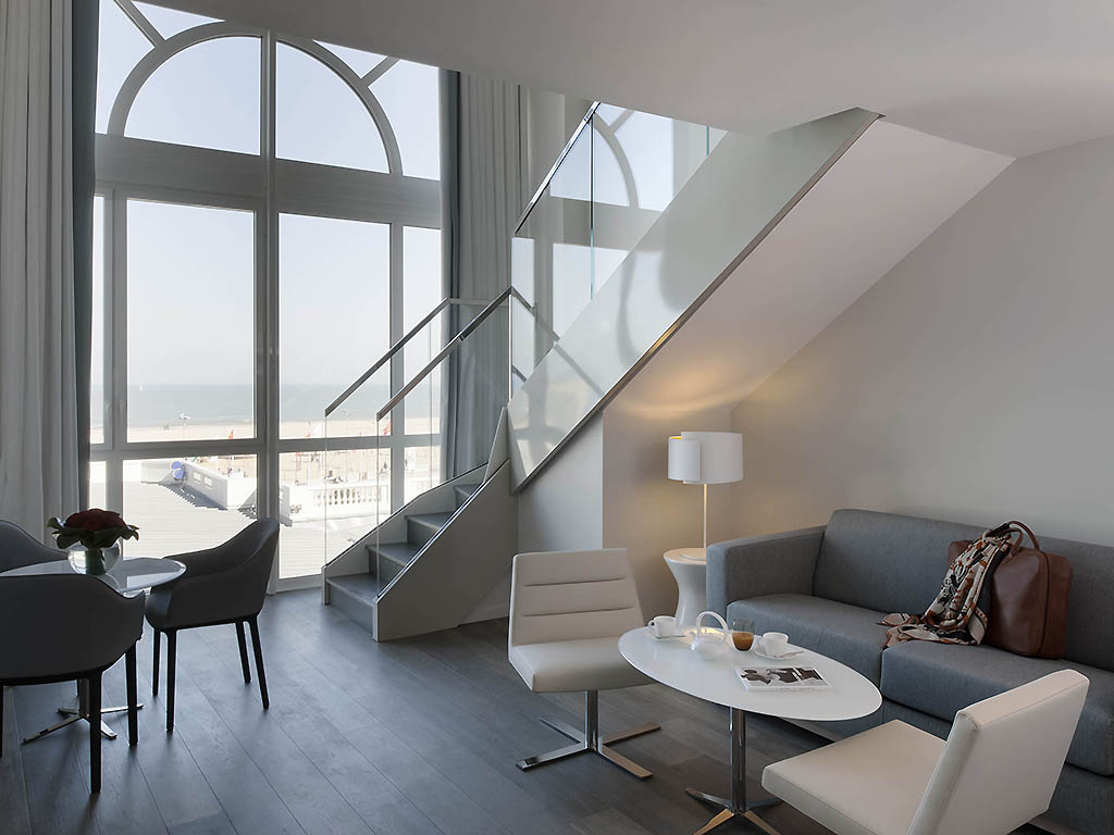a living room with a staircase and a couch