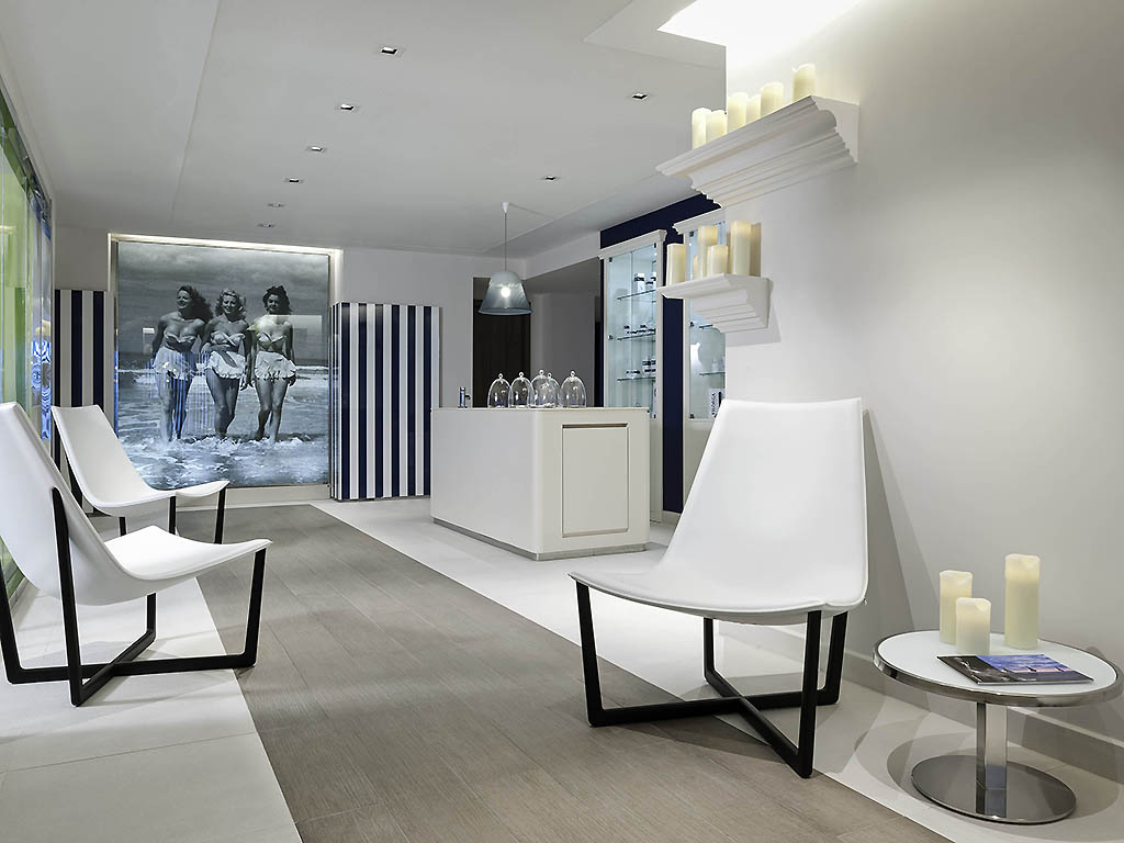 a white room with white chairs and a table