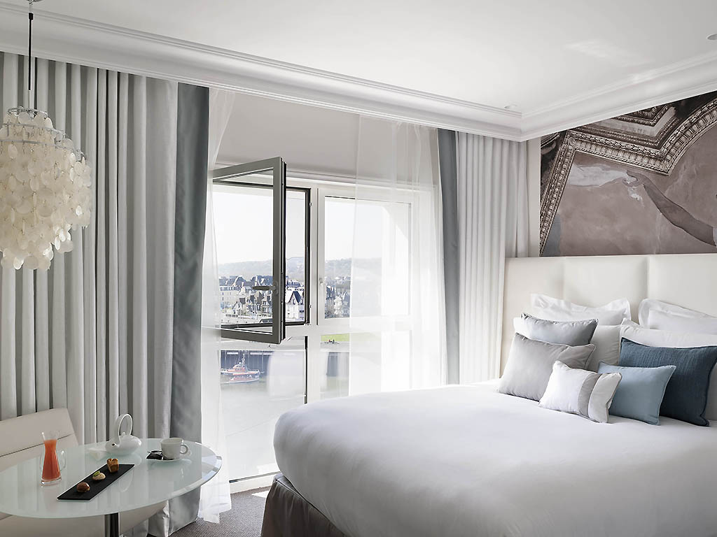 a bedroom with a bed and a glass door