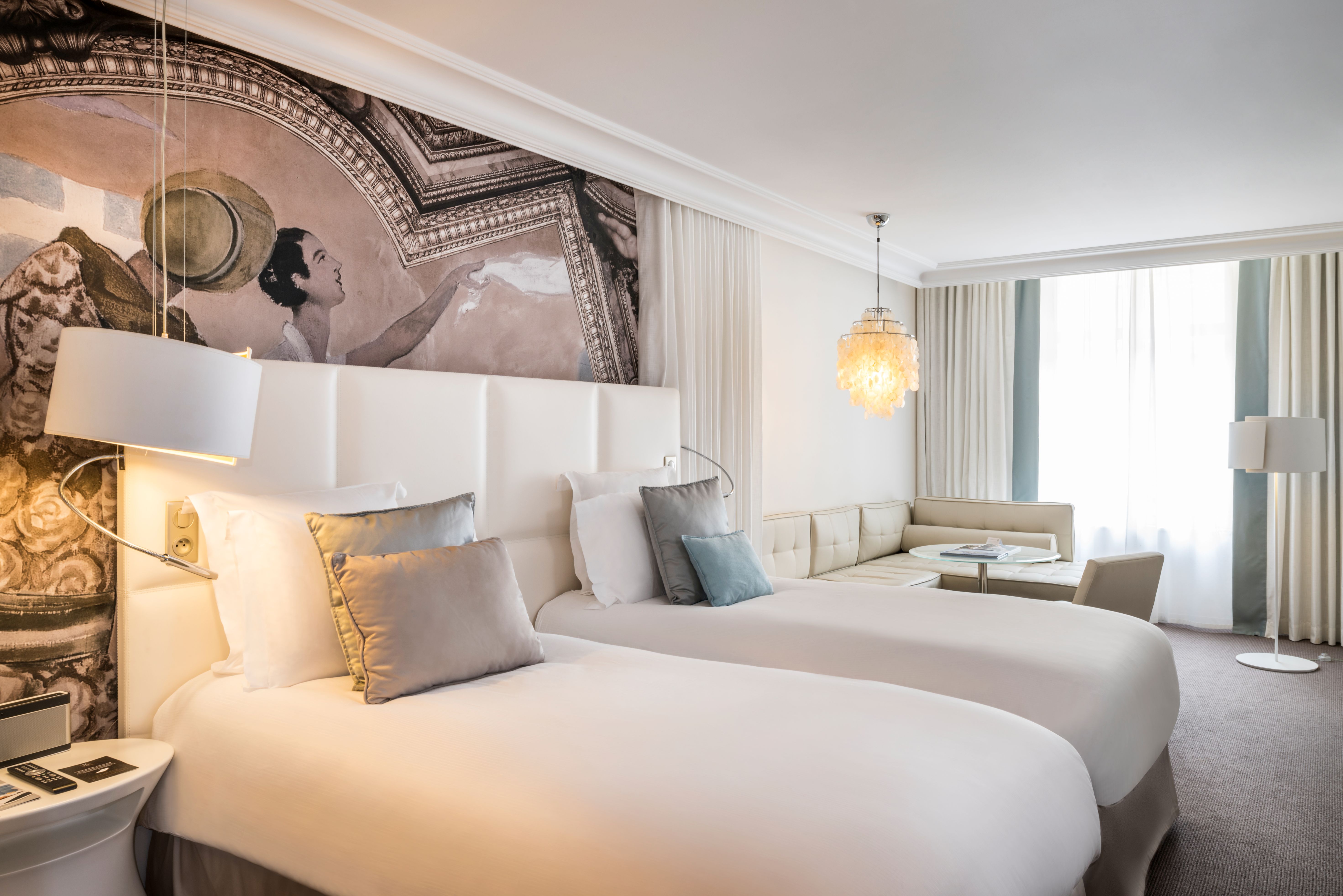 a room with two beds and a table