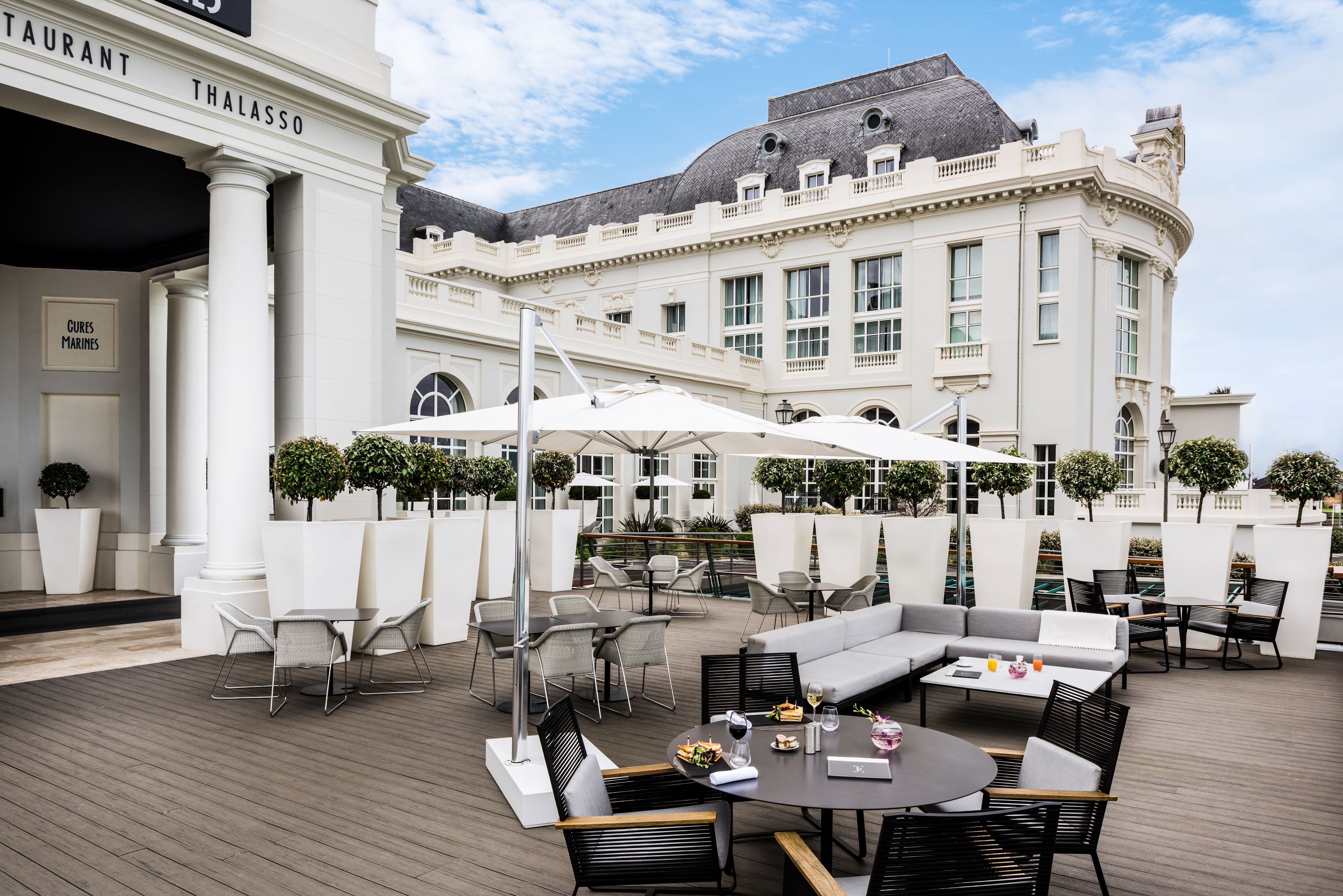 a patio with tables and chairs outside of a building