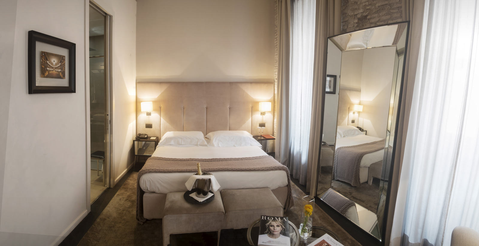 a bedroom with a large mirror and a bed