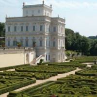 a white building with a maze in front of it