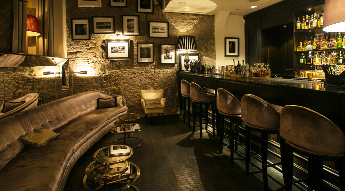 a bar with a couch and chairs