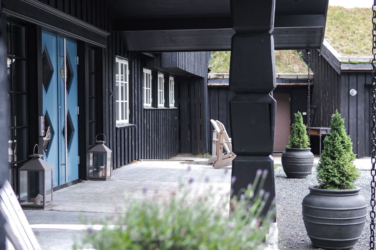 a porch with a blue door and a white chair