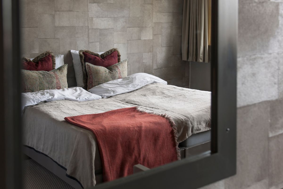 a bed with pillows and blankets