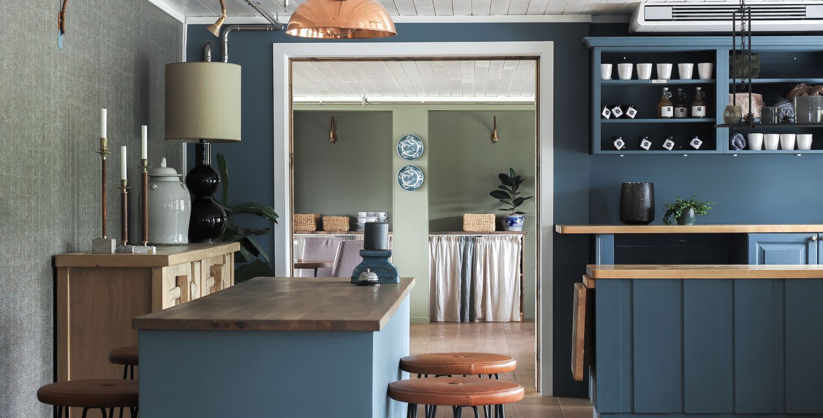 a kitchen with blue walls and a wood countertop
