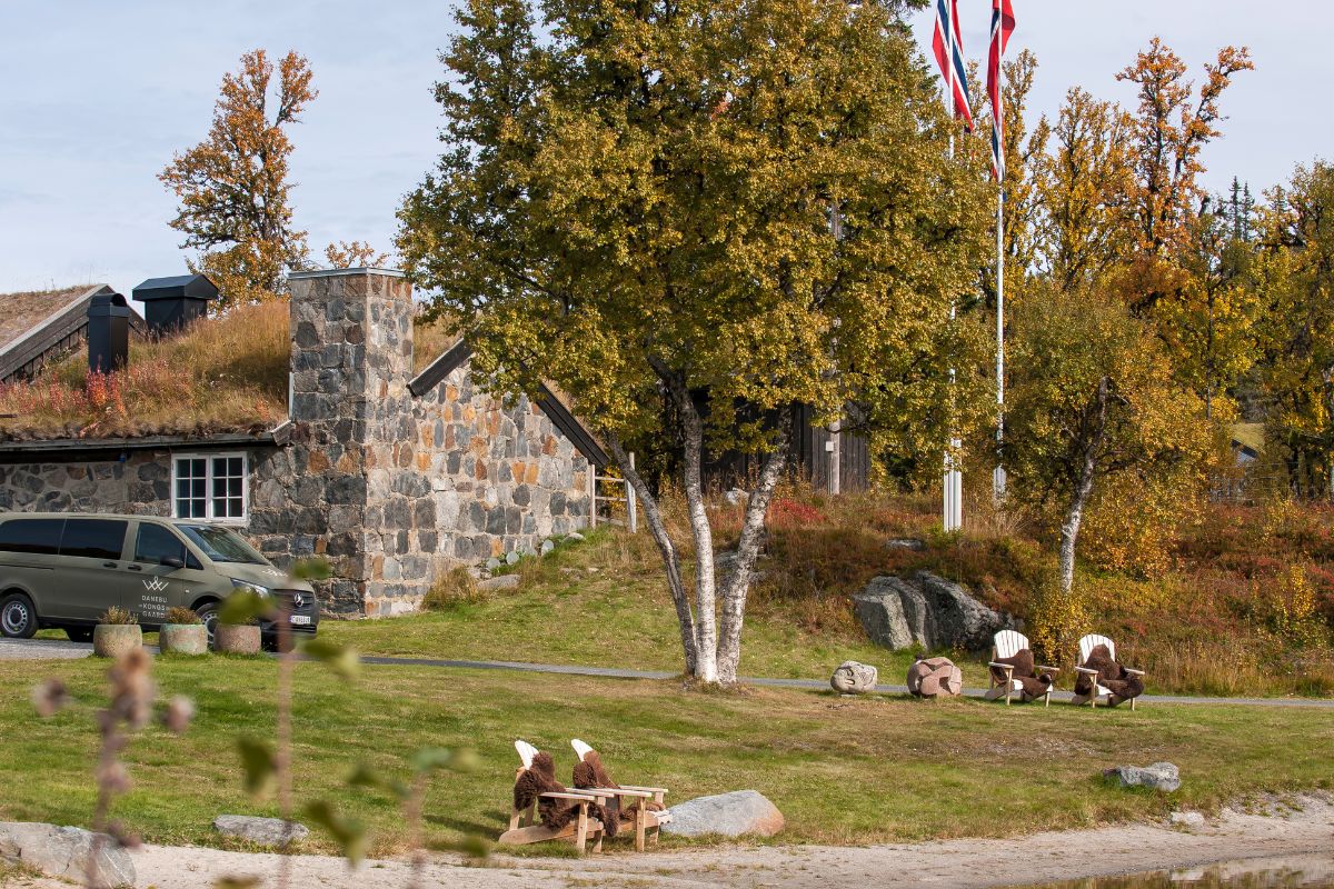 a lawn chairs and a building with trees and flags