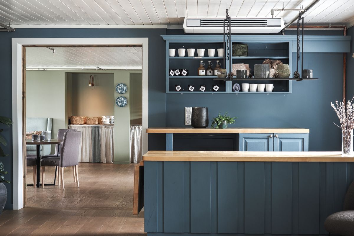 a kitchen with a blue wall and a table