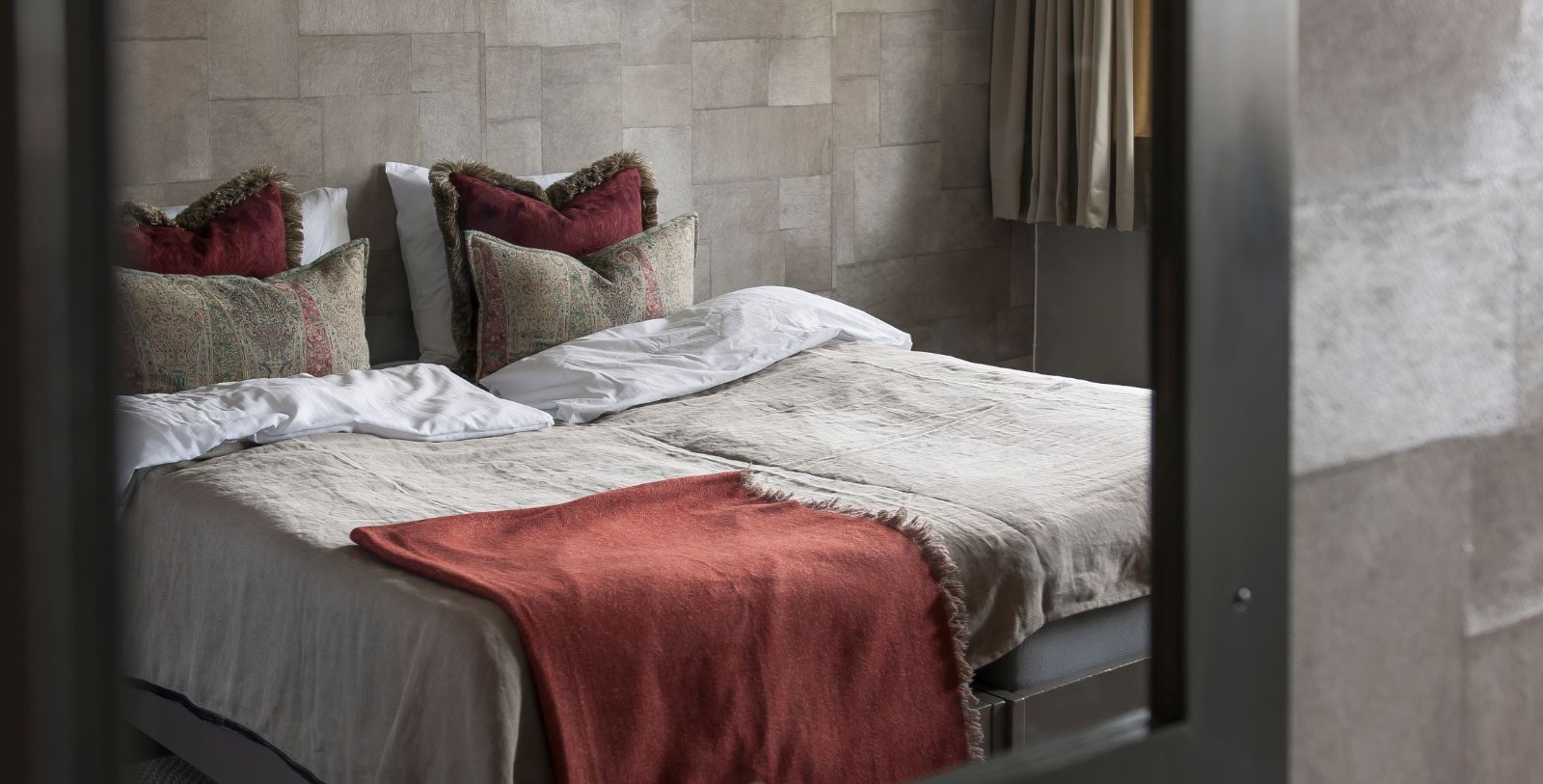 a bed with pillows and blankets