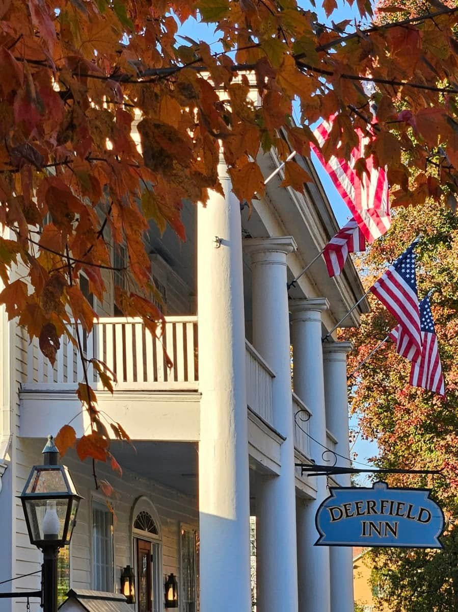 a building with a sign and flags