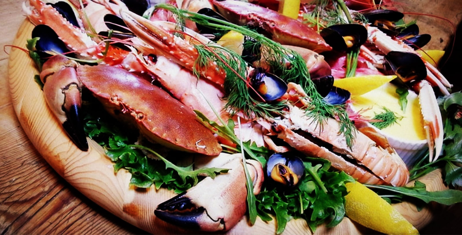 a plate of seafood on a wooden surface